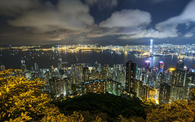 High angle view of illuminated buildings against sky at night