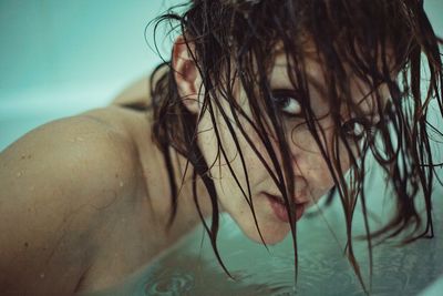 Close-up portrait of young woman in swimming pool