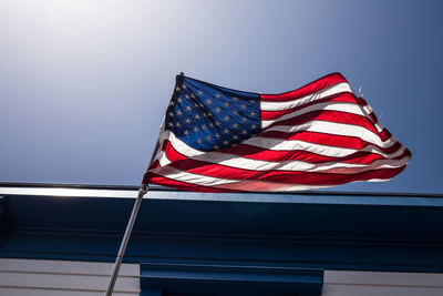 Low angle view of flag flags against clear sky