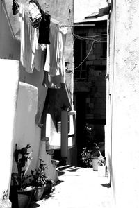Clothes drying on alley amidst buildings in town