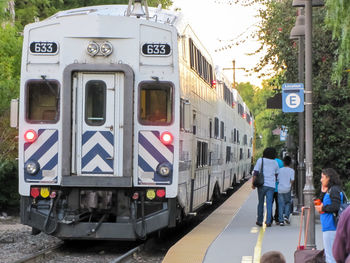 People on train on street in city