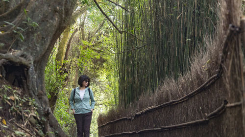 Rear view of man standing in forest