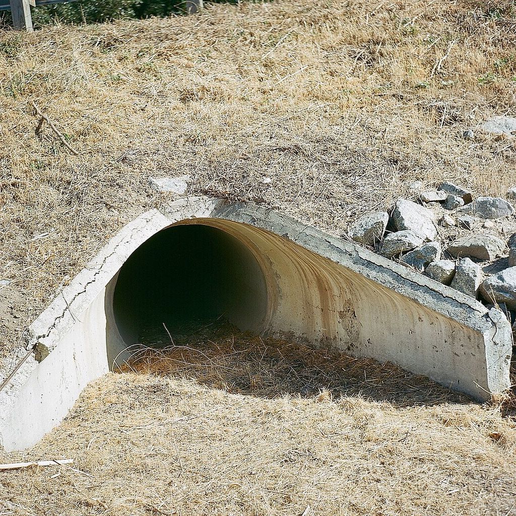 built structure, stone - object, textured, high angle view, circle, outdoors, no people, day, architecture, abandoned, old, sunlight, weathered, stone, street, close-up, wall - building feature, hole, damaged, nature