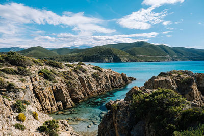 Scenic view of sea and mountains against sky