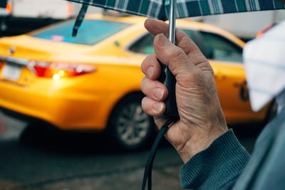 Midsection of person holding umbrella