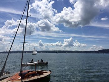 Boats sailing in sea against sky