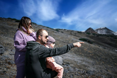 Side view of man standing on mountain