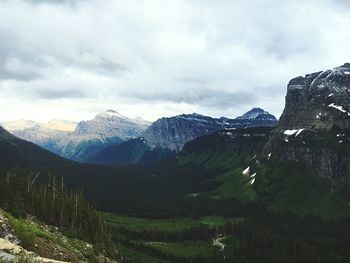 Scenic view of mountains against cloudy sky