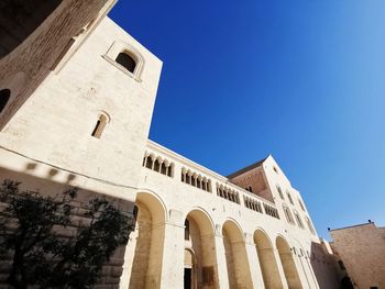 Low angle view of historic building against clear blue sky