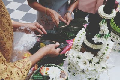 Midsection of woman holding flower bouquet