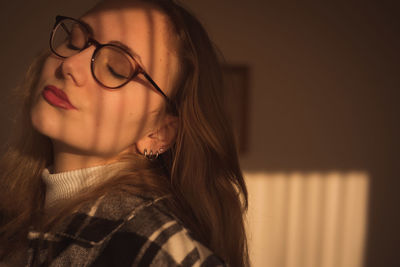 Close-up of teenager with closed eyes at home