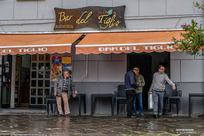 People standing by restaurant