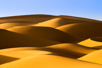 Scenic view of desert against clear sky