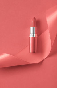 High angle view of lipstick against yellow background