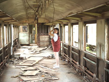 Woman standing in abandoned building