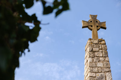 Low angle view of statue against sky