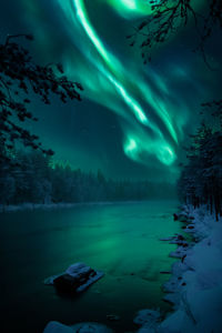 Scenic view of river against sky at night