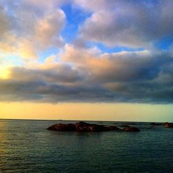 Scenic view of sea against cloudy sky