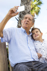 Grandfather taking selfie with grandson