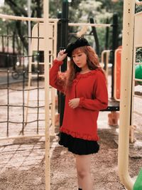 Full length of young woman standing outdoors