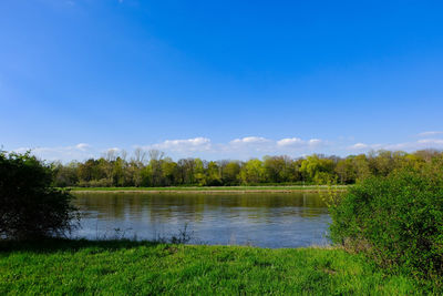 Scenic view of lake against blue sky
