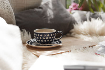 Close-up of coffee cup on table at home