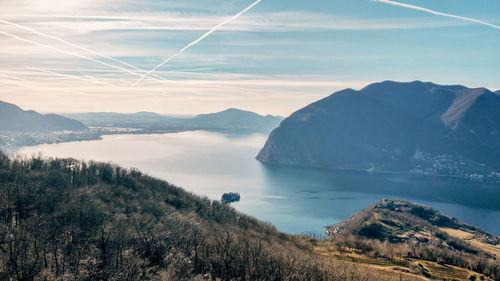 Scenic view of sea and mountains against sky