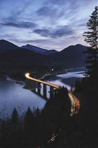 Scenic view of lake by mountains against sky