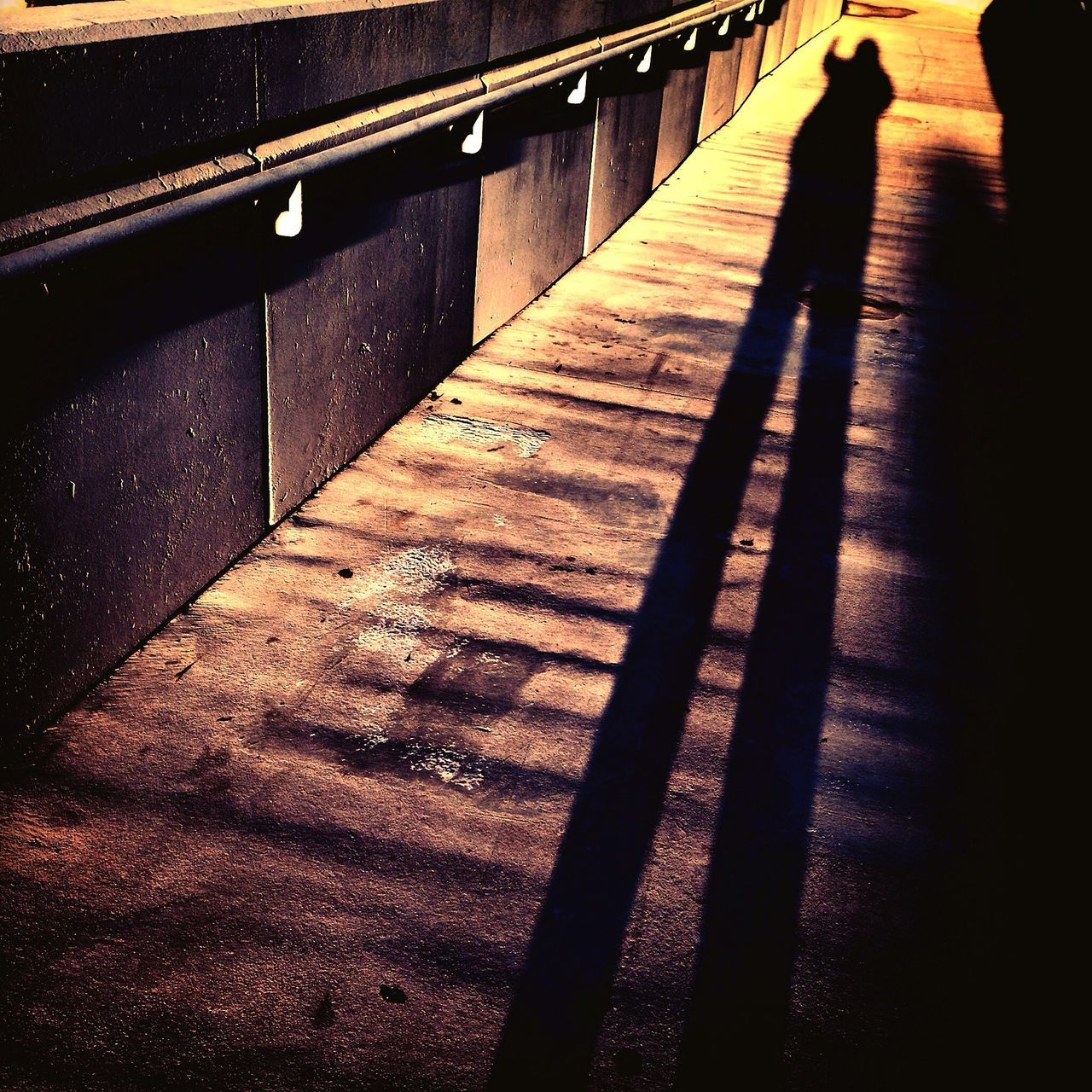 steps, shadow, steps and staircases, high angle view, staircase, railing, sunlight, night, indoors, built structure, focus on shadow, silhouette, the way forward, in a row, street, wall - building feature, architecture, pattern, no people