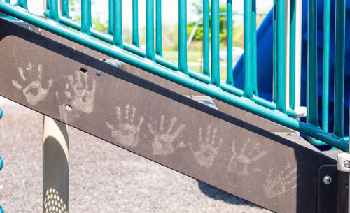 Close-up of railing against blue wall