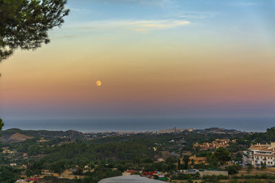 Aerial view of townscape against sky at sunset