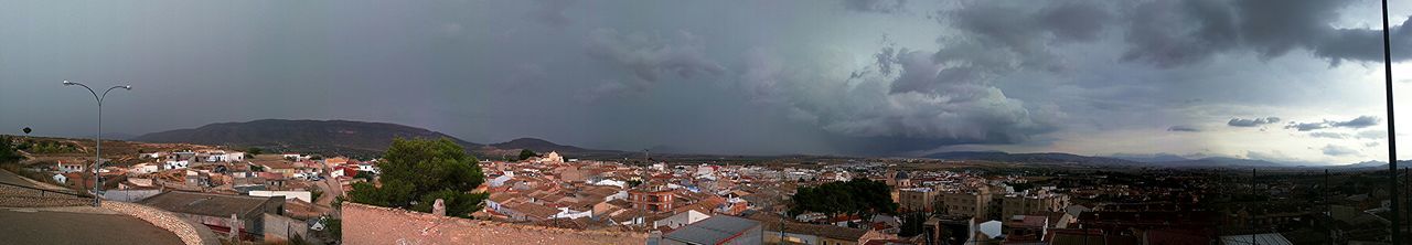 View of cityscape against cloudy sky