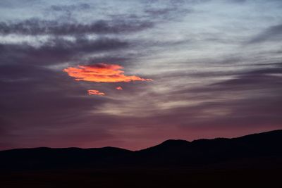 Scenic view of silhouette mountains against sky at sunset