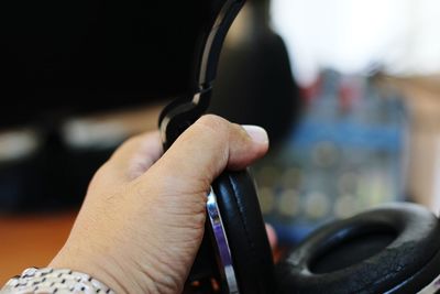 Close-up of hand holding headphones