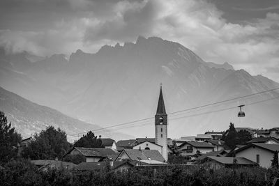 Panoramic view of buildings and mountains against sky