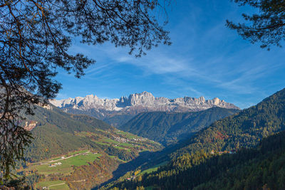 Catinaccio  peaks visible through an opening in the trees, tires valley, south tyrol, italy