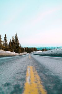 Surface level of road against clear sky