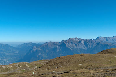 Scenic view of mountains against clear blue sky