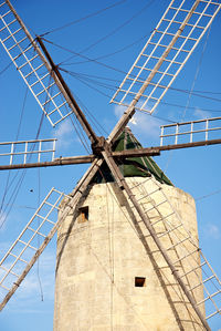 Low angle view of traditional windmill against sky