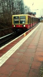 Train at railroad station against sky