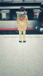 Low section of woman standing on road