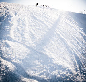 People skiing on snow covered landscape