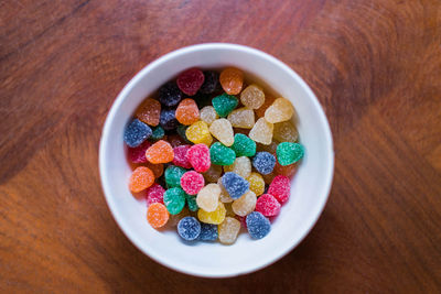 Close-up of multi colored candies in bowl on table