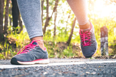 Low section of woman walking on street