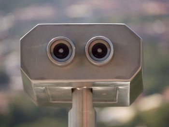 Close-up of coin-operated binoculars against blurred background