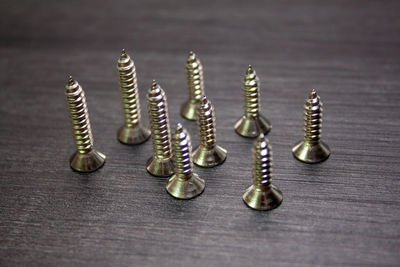 Close-up of screws on wooden table