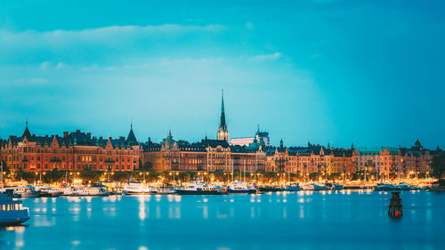 Buildings and harbor against blue sky