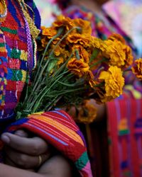 Midsection of woman holding bouquet