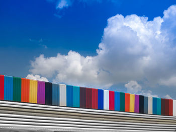 Low angle view of multi colored building against blue sky