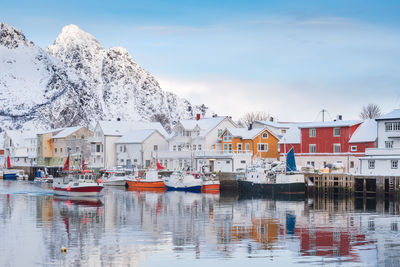 Boats moored in lake during winter